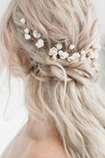 Load image into Gallery viewer, Blonde hair with floral hairpiece against a neutral background