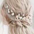 Load image into Gallery viewer, Blonde hair with floral hairpiece against a neutral background