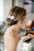 Load image into Gallery viewer, Woman with elegant hair styled with floral hairpiece in an indoor setting