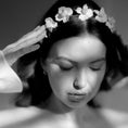 Load image into Gallery viewer, Black and white photo of a woman with a floral headpiece, softly lit.