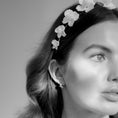 Load image into Gallery viewer, Black and white close-up of a woman wearing a floral headband with a neutral background