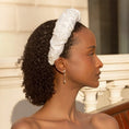 Load image into Gallery viewer, Woman wearing a white bridal headband with a blurred background