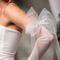 Load image into Gallery viewer, White tulle bow on a person wearing a white dress, with a blurred background.