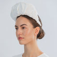 Load image into Gallery viewer, Woman wearing a white bridal headband against a light grey background
