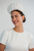 Load image into Gallery viewer, Woman wearing a white bridal headband against a light grey background