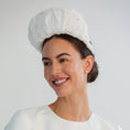 Load image into Gallery viewer, Woman wearing a white bridal headband against a light grey background