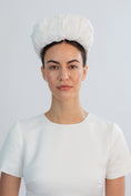 Load image into Gallery viewer, Woman wearing a white bridal headband against a light grey background