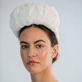 Load image into Gallery viewer, Woman wearing a white bridal headband against a light grey background