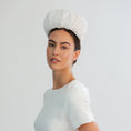 Load image into Gallery viewer, Woman wearing a white bridal headband against a light grey background