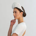 Load image into Gallery viewer, Woman wearing a white bridal headband against a light gray background