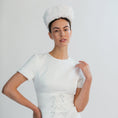 Load image into Gallery viewer, Woman wearing a white bridal headband against a light grey background