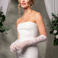 Load image into Gallery viewer, Woman in a white strapless dress with gloves standing against a neutral background