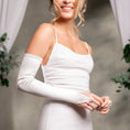 Load image into Gallery viewer, Woman wearing a white dress with long sleeves against a neutral background