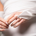 Load image into Gallery viewer, Close-up of a hand wearing a white glove with a pearl button on a neutral background