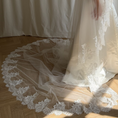 Bild in Galerie-Betrachter laden, Bride wearing a white wedding dress with a lace veil against a white curtain background.