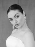 Load image into Gallery viewer, Black and white portrait of a woman wearing earrings against a plain background