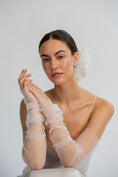 Load image into Gallery viewer, Bride wearing sheer white gloves and bridal hair scrunchie against a plain background