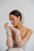 Load image into Gallery viewer, Bride wearing sheer white gloves and bridal hair scrunchie against a plain background
