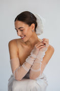 Load image into Gallery viewer, Bride wearing sheer white gloves and bridal hair scrunchie against a plain background