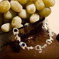 Load image into Gallery viewer, bracelet with a sapphire displayed on a bowl of grapes