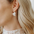 Load image into Gallery viewer, Close-up of a person wearing a delicate earring with a blurred background