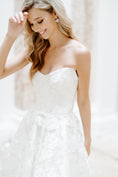 Load image into Gallery viewer, Woman wearing a white strapless dress against a plain background