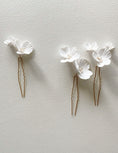 Load image into Gallery viewer, Two floral hair pins on a light gray background