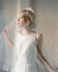 Load image into Gallery viewer, Woman in a white wedding dress with a veil against a neutral background