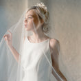 Load image into Gallery viewer, Woman in a white wedding dress with a veil against a neutral background
