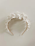 Load image into Gallery viewer, White floral headband on a light gray background