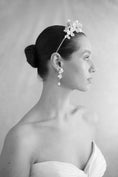 Load image into Gallery viewer, Black and white portrait of a woman wearing a floral headpiece and earrings.