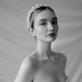 Load image into Gallery viewer, Black and white portrait of a woman wearing a floral headband against a plain background