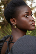Load image into Gallery viewer, Woman with styled hair wearing earrings against a blurred natural background