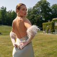 Load image into Gallery viewer, Woman in a elegant dress with feathered bridal gloves standing in a park.