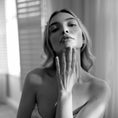 Load image into Gallery viewer, Black and white photo of a woman holding her hand to her face.
