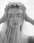 Load image into Gallery viewer, Black and white photo of a person wearing a veil with floral accents.