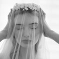 Load image into Gallery viewer, Black and white photo of a person wearing a veil with floral accents.