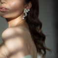 Load image into Gallery viewer, Close-up of a woman wearing elegant earrings with a blurred background