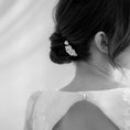 Load image into Gallery viewer, Black and white photo of a person wearing a delicate floral hair accessory.