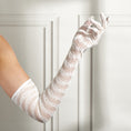Load image into Gallery viewer, White lace gloves being worn against a white wooden panel background
