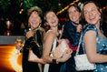 Load image into Gallery viewer, Four women laughing together at a social event with festive decorations wearing bridal bag
