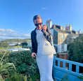 Load image into Gallery viewer, Woman in a white dress with a beaded bridal bag standing on a balcony with a scenic view.