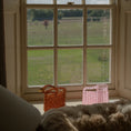 Load image into Gallery viewer, View from a window with a grassy field and cloudy sky outside with bridal bags
