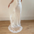 Charger l'image dans la visionneuse de la galerie, Model wearing White lace veil and wedding dress on a wooden floor with a plain white wall background