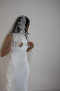 Load image into Gallery viewer, Model wearing White lace veil and wedding dress on a wooden floor with a plain white wall background