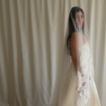 Bild in Galerie-Betrachter laden, Bride wearing a white wedding dress with a lace veil against a white curtain background.