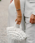Load image into Gallery viewer, bride holding nest handbag in white