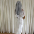 Bild in Galerie-Betrachter laden, Person wearing a white lace wedding dress with a long veil in front of white curtains.
