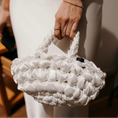 Load image into Gallery viewer, bride holding nest bridal handbag in bright white