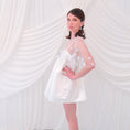 Load image into Gallery viewer, A young girl modeling a short white slip dress with a tulle petal bridal cape and white pointed-toe heels, standing against a draped white fabric backdrop.
